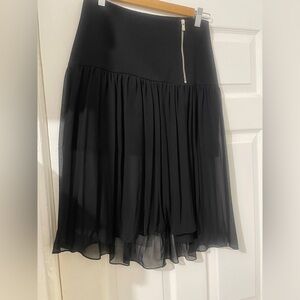 Sandro sheer skirt with a mini under pleaded skirt.